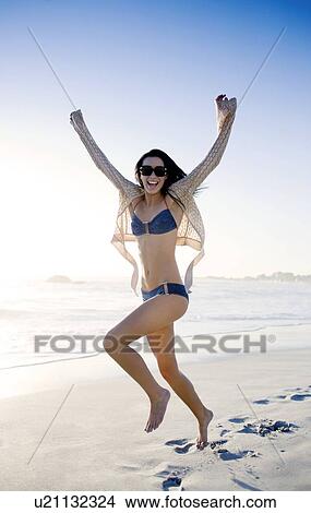 Picture - Happy woman on a beach. Fotosearch
