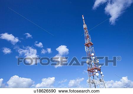 Stock Image - Low angle view of communication tower against blue sky. Fotosearch