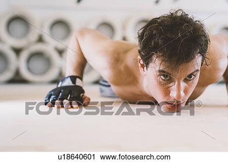 Stock Image - Man doing press ups. Fotosearch