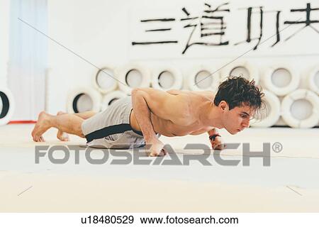 Stock Photo - Man doing push up on fists. Fotosearch