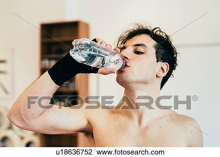 Stock Image - Man drinking water from bottle. Fotosearch