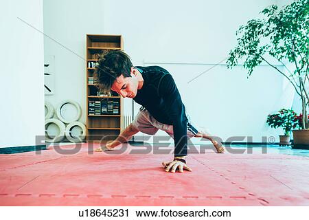 Man in gym, hand behind back doing push up View Large Photo Image Stock Image - Man in gym, hand behind back doing push up. Fotosearch