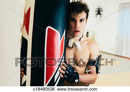Man in gym wearing heart rate monitor holding punch bag looking at camera View Large Photo Image Stock Photo - Man in gym wearing heart rate monitor holding punch bag looking at camera. Fotosearch