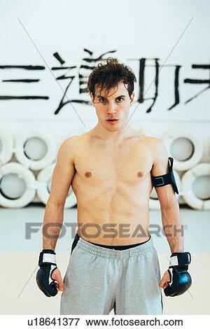 Man in gym wearing kickboxing gloves and heart rate monitor looking at camera View Large Photo Image Stock Photo - Man in gym wearing kickboxing gloves and heart rate monitor looking at camera. Fotosearch