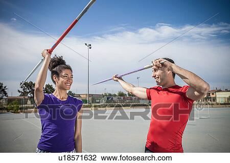 Man instructing female javelin thrower at sports ground View Large Photo Image Stock Image - Man instructing female javelin thrower at sports ground. Fotosearch
