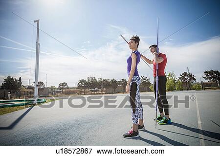 Man instructing female javelin thrower at sports ground View Large Photo Image Stock Photo - Man instructing female javelin thrower at sports ground. Fotosearch