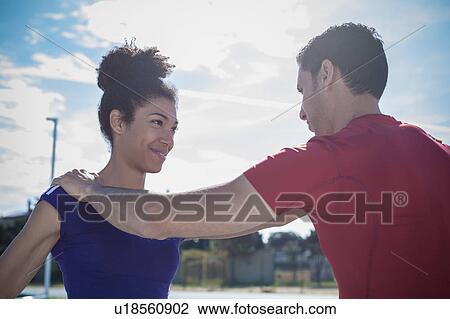 Man instructing young woman training at sport facility View Large Photo Image Stock Image - Man instructing young woman training at sport facility. Fotosearch