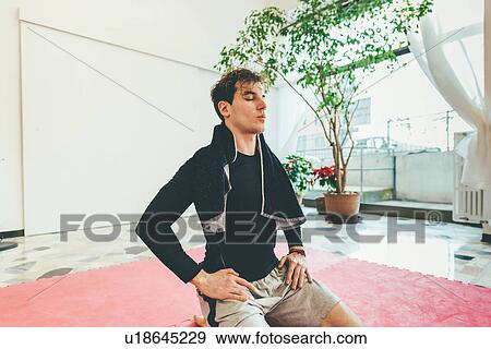 Man kneeling, eyes closed meditating View Large Photo Image Stock Photo - Man kneeling, eyes closed meditating. Fotosearch