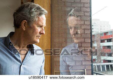 Man looking through window View Large Photo Image Stock Photo - Man looking through window. Fotosearch
