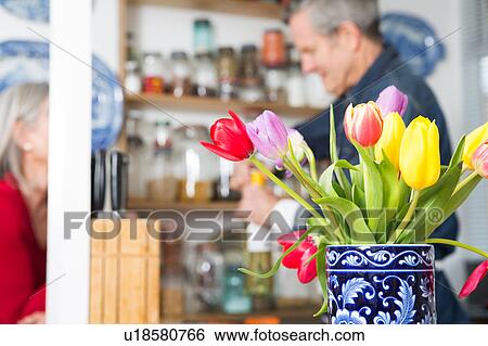 Man opening bottle of wine in kitchen View Large Photo Image Stock Photograph - Man opening bottle of wine in kitchen. Fotosearch