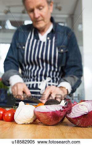 Man preparing food in kitchen View Large Photo Image Stock Photography - Man preparing food in kitchen. Fotosearch