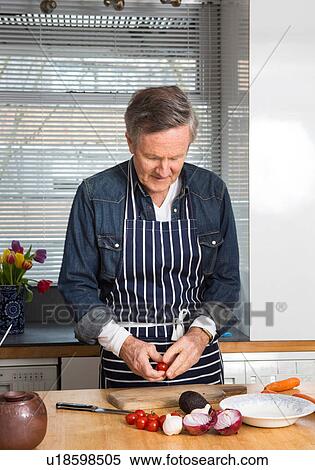 Man preparing food in kitchen View Large Photo Image Stock Photography - Man preparing food in kitchen. Fotosearch