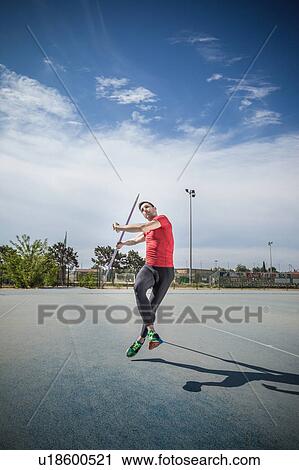 Man throwing javelin in sports ground View Large Photo Image Stock Image - Man throwing javelin in sports ground. Fotosearch