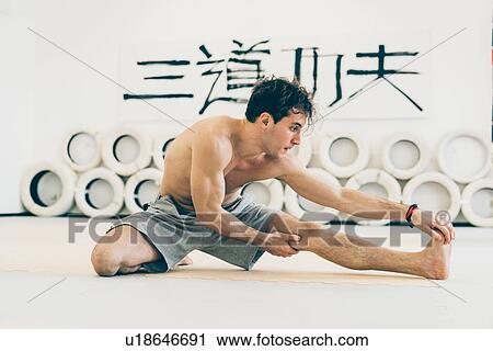 Man touching toes doing leg stretching exercises View Large Photo Image Stock Image - Man touching toes doing leg stretching exercises. Fotosearch