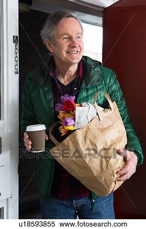 Man with groceries and cup of coffee View Large Photo Image Stock Photography - Man with groceries and cup of coffee. Fotosearch