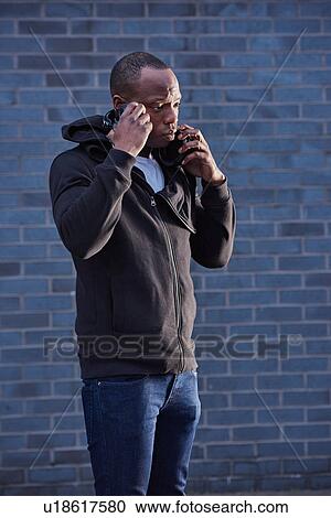 Man with headphones, listening View Large Photo Image Stock Image - Man with headphones, listening. Fotosearch