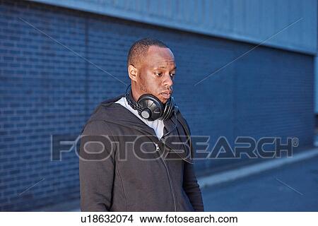 Man with headphones looking away View Large Photo Image Picture - Man with headphones looking away. Fotosearch