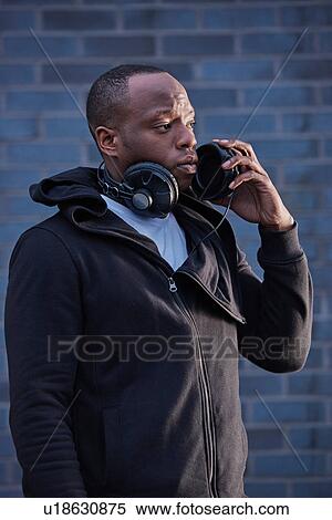 Stock Photography - Man with headphones looking away. Fotosearch