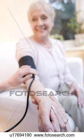 Stock Image - Measuring blood pressure. Fotosearch