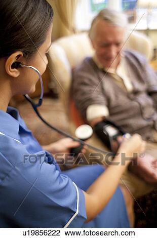 Stock Image - Measuring blood pressure. Fotosearch