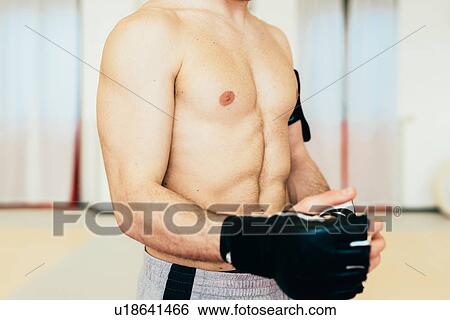 Mid section of bare chested man wearing kickboxing gloves View Large Photo Image Stock Photograph - Mid section of bare chested man wearing kickboxing gloves. Fotosearch