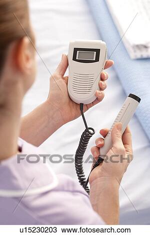 Midwife with a doppler monitor View Large Photo Image Stock Image - Midwife with a doppler monitor. Fotosearch