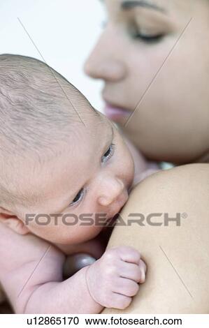 Stock Image - Mother and newborn baby girl. Fotosearch