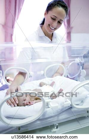 Nurse and premature baby View Large Photo Image Picture - Nurse and premature baby. Fotosearch