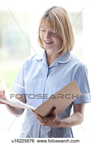 Nurse checking notes View Large Photo Image Stock Photograph - Nurse checking notes. Fotosearch