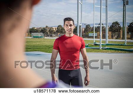 Over shoulder view of young man training at sport facility View Large Photo Image Stock Photo - Over shoulder view of young man training at sport facility. Fotosearch
