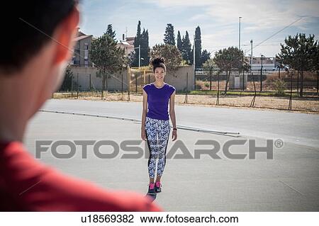 Over shoulder view of young woman training at sport facility View Large Photo Image Stock Image - Over shoulder view of young woman training at sport facility. Fotosearch