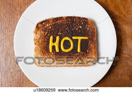 Overhead view of the word hot written in mustard on burnt toast View Large Photo Image Stock Photo - Overhead view of the word hot written in mustard on burnt toast. Fotosearch