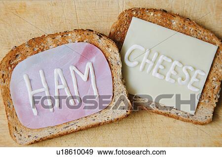 Stock Photo - Overhead view of the words ham and cheese written on toast in mayonnaise. Fotosearch
