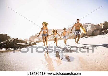 Parents and two children running on beach, Cape Town, South Africa View Large Photo Image Stock Photo - Parents and two children running on beach, Cape Town, South Africa. Fotosearch