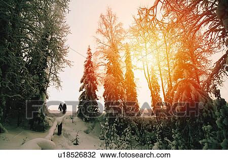 Stock Image - People in the distance on snow covered ridge. Fotosearch