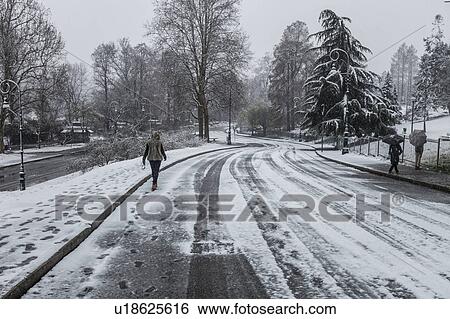 People walking on snow covered road View Large Photo Image Stock Photograph - People walking on snow covered road. Fotosearch