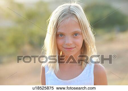 Stock Photography - Portrait of blond blue eyed girl, Buonconvento, Tuscany, Italy. Fotosearch