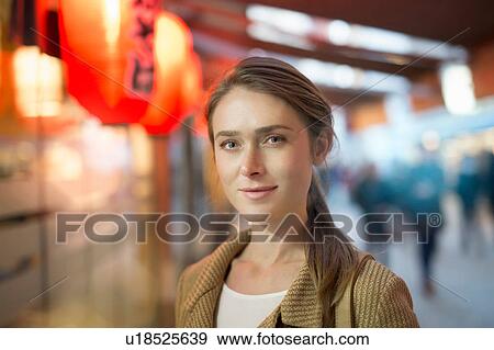 Stock Photo - Portrait of businesswoman on city street at night. Fotosearch