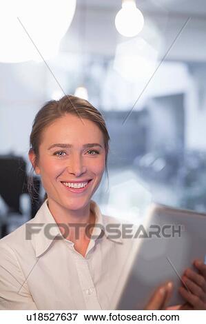 Portrait of businesswoman using digital tablet in office View Large Photo Image Stock Photo - Portrait of businesswoman using digital tablet in office. Fotosearch