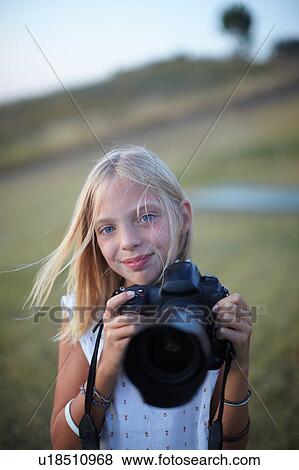 Stock Photo - Portrait of girl photographing with digital slr, Buonconvento, Tuscany, Italy. Fotosearch