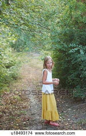 Picture - Portrait of girl standing in woodland, Buonconvento, Tuscany, Italy. Fotosearch