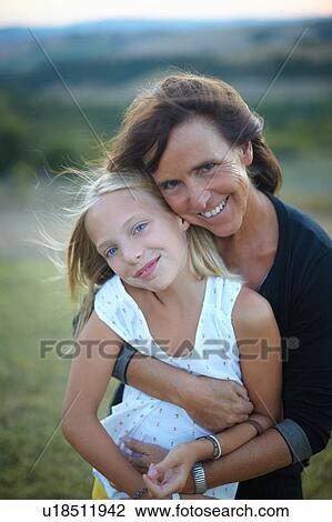 Portrait of senior woman hugging granddaughter, Buonconvento, Tuscany, Italy View Large Photo Image Stock Image - Portrait of senior woman hugging granddaughter, Buonconvento, Tuscany, Italy. Fotosearch