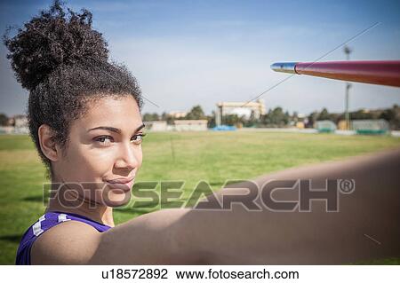Portrait of young female javelin thrower in sports ground View Large Photo Image Stock Image - Portrait of young female javelin thrower in sports ground. Fotosearch