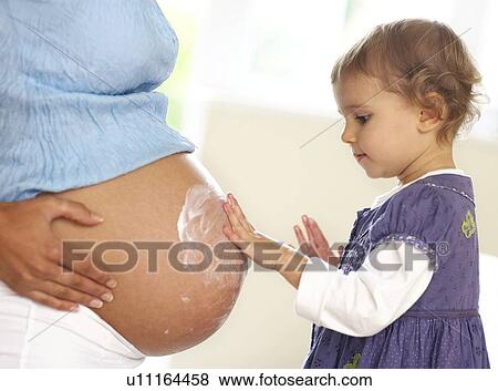 Pregnant woman and daughter View Large Photo Image Stock Photo - Pregnant woman and daughter. Fotosearch