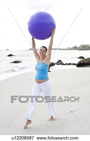 Stock Photo - Pregnant woman exercising. Fotosearch
