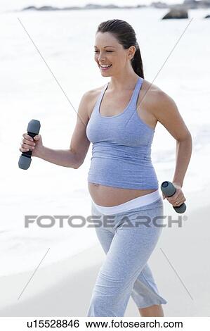 Pregnant woman exercising View Large Photo Image Stock Photograph - Pregnant woman exercising. Fotosearch