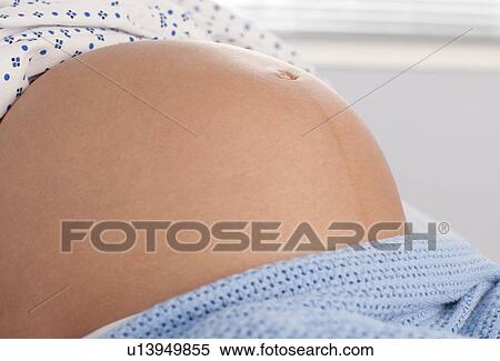 Stock Photography - Pregnant woman's abdomen. Fotosearch