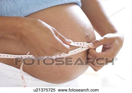 Stock Photography - Pregnant woman's abdomen. Fotosearch