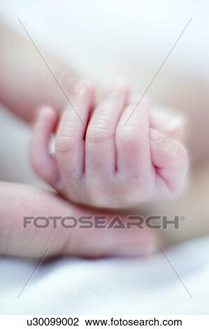 Stock Image - Premature baby's hand. Fotosearch