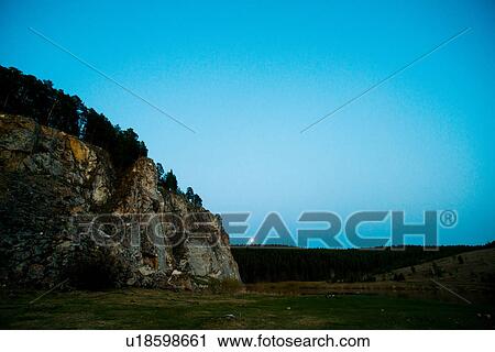 Rock face in rolling landscape View Large Photo Image Stock Image - Rock face in rolling landscape. Fotosearch